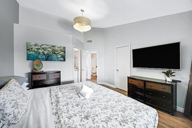 20822 N 34th Dr, Phoenix, AZ 85027 - bedroom featuring wood finished floors, baseboards, and connected bathroom