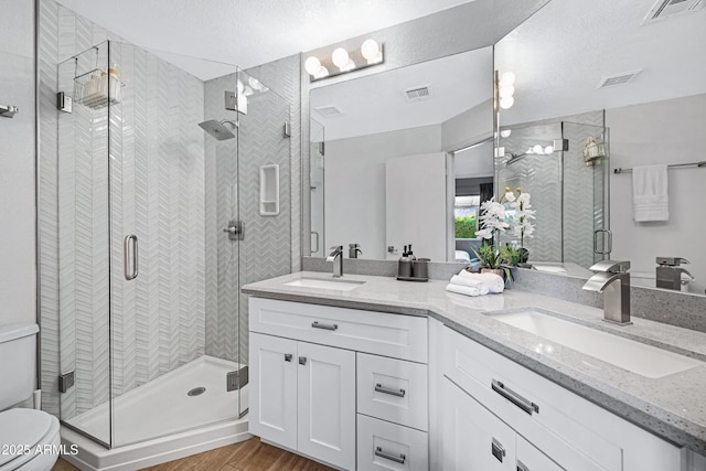 20822 N 34th Dr, Phoenix, AZ 85027 - full bath featuring a shower stall, double vanity, toilet, wood finished floors, and a textured ceiling