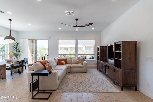 living room with ceiling fan and light hardwood / wood-style floors