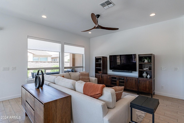 living room featuring ceiling fan and light hardwood / wood-style floors