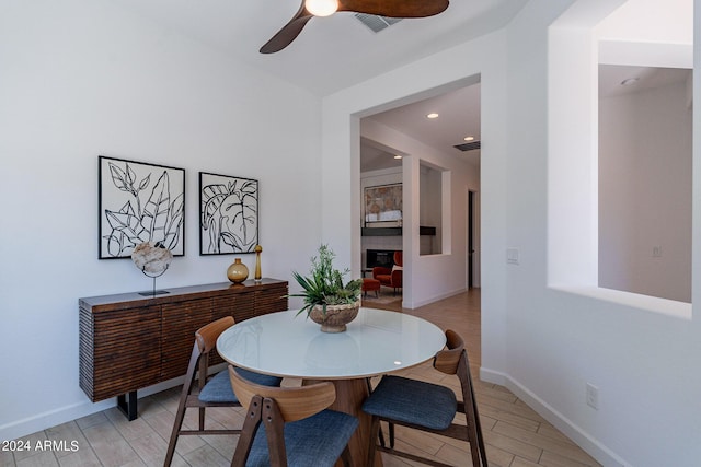 dining area with ceiling fan and light hardwood / wood-style floors