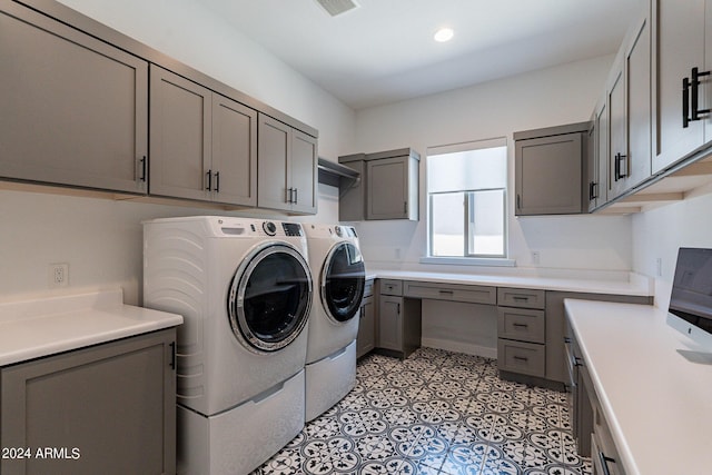 laundry room with cabinets and washer and dryer