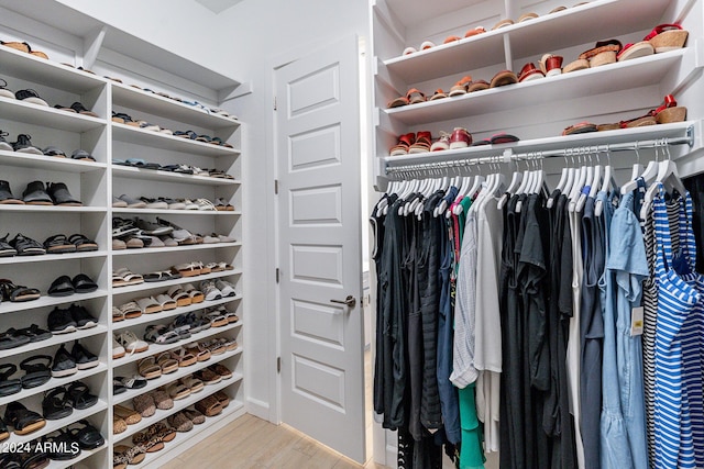 spacious closet featuring light hardwood / wood-style flooring