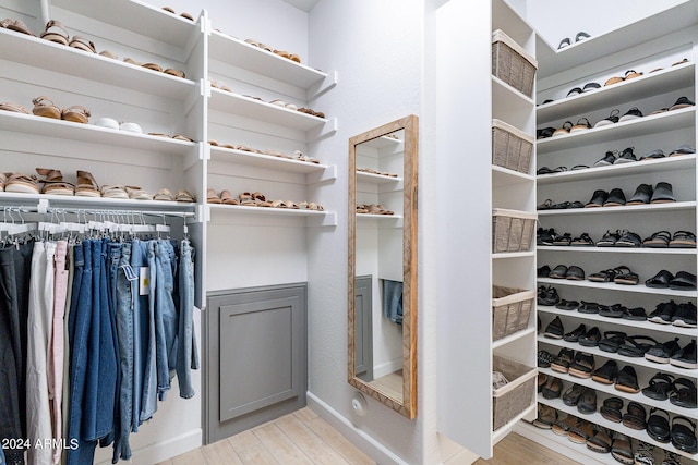 spacious closet with light hardwood / wood-style flooring