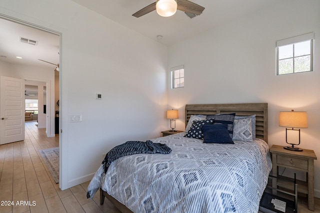 bedroom with ceiling fan and light wood-type flooring