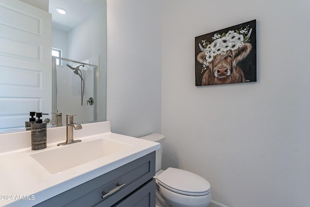 bathroom with walk in shower, vanity, and toilet