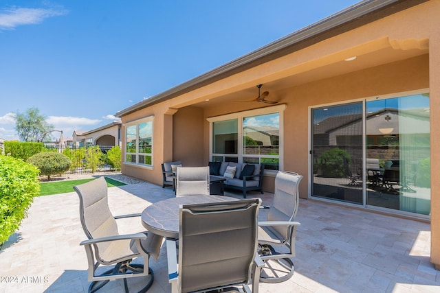 view of patio with an outdoor living space and ceiling fan