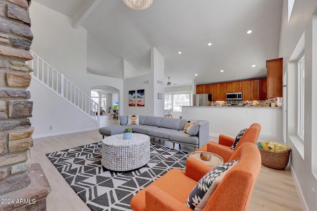 living room featuring high vaulted ceiling, ceiling fan, and light hardwood / wood-style flooring