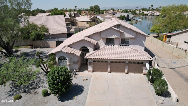 view of front of house featuring a garage and a water view