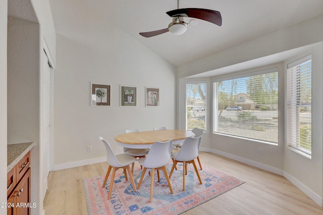 dining area featuring high vaulted ceiling, ceiling fan, and light hardwood / wood-style floors