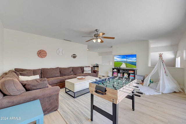 living room with a healthy amount of sunlight, ceiling fan, and light hardwood / wood-style floors