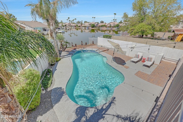 view of swimming pool with a water view and a patio area