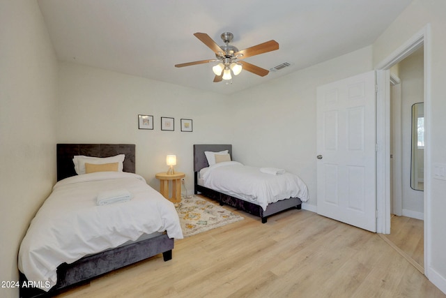 bedroom with light hardwood / wood-style flooring and ceiling fan