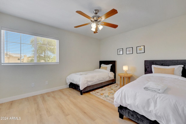 bedroom with ceiling fan and light hardwood / wood-style flooring