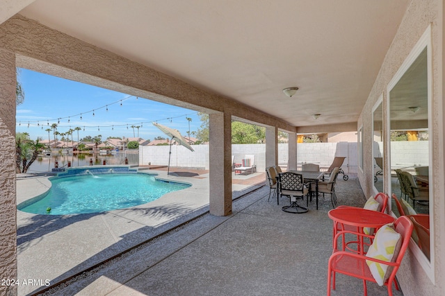 view of pool with pool water feature and a patio