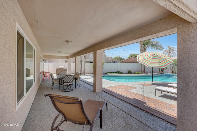 view of patio with a fenced in pool