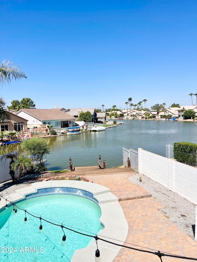 view of swimming pool featuring a water view