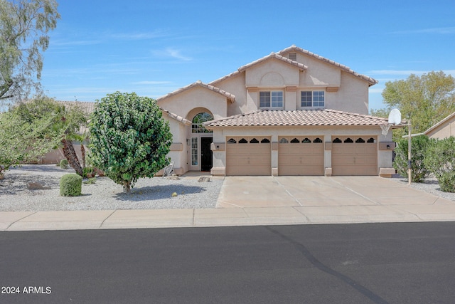 mediterranean / spanish-style house with a garage