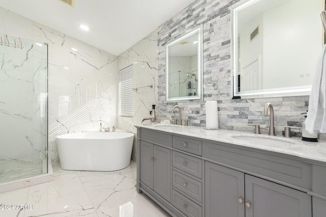 bathroom with vanity, tile walls, independent shower and bath, and tasteful backsplash