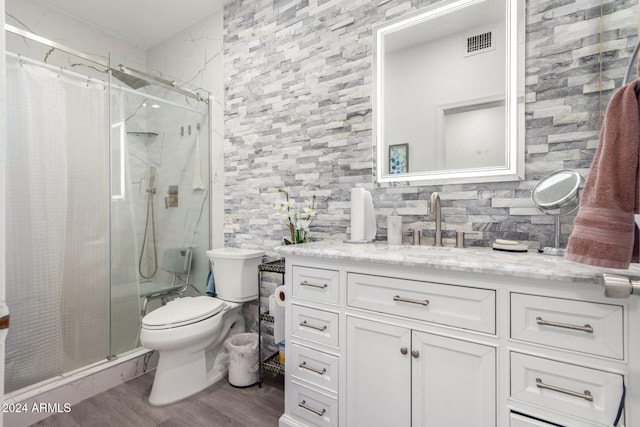 bathroom featuring curtained shower, backsplash, toilet, vanity, and hardwood / wood-style flooring