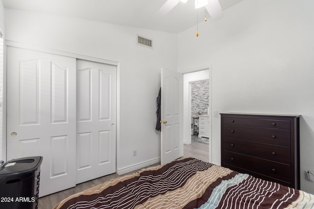 bedroom with ceiling fan, a closet, and light hardwood / wood-style flooring