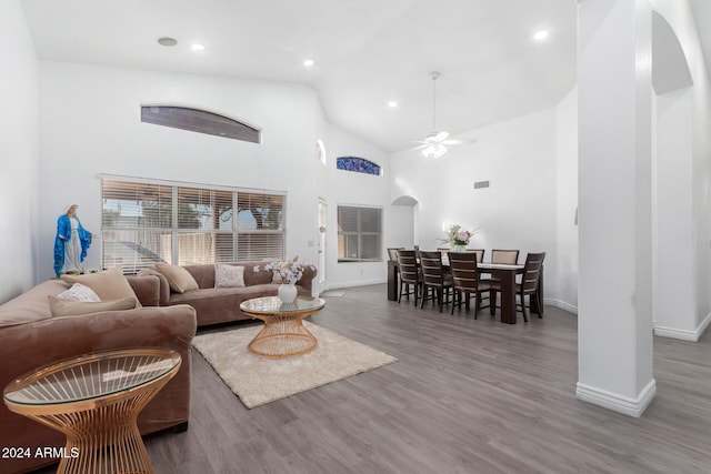 living room with dark hardwood / wood-style floors, high vaulted ceiling, and ceiling fan