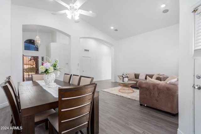 dining space featuring ceiling fan, high vaulted ceiling, and hardwood / wood-style flooring