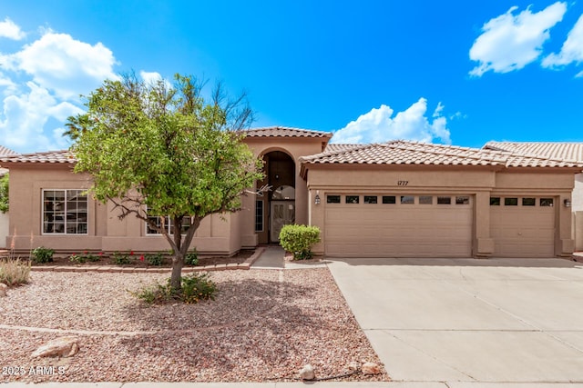 1777 W Redfield Rd, Gilbert, AZ 85233 - mediterranean / spanish house featuring an attached garage, a tiled roof, driveway, and stucco siding
