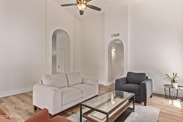 1777 W Redfield Rd, Gilbert, AZ 85233 - living room with high vaulted ceiling, arched walkways, a ceiling fan, and baseboards