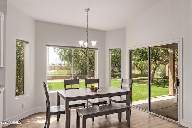 1777 W Redfield Rd, Gilbert, AZ 85233 - dining room with light wood finished floors, a chandelier, and a healthy amount of sunlight