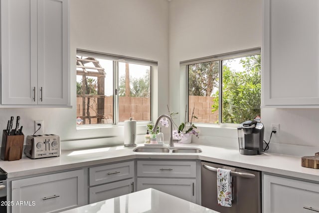 1777 W Redfield Rd, Gilbert, AZ 85233 - kitchen featuring light countertops, stainless steel dishwasher, white cabinetry, and a sink