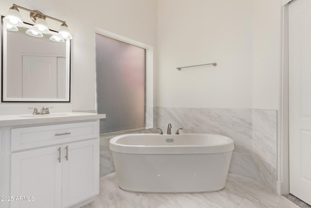 1777 W Redfield Rd, Gilbert, AZ 85233 - full bath featuring a wainscoted wall, tile walls, a freestanding tub, marble finish floor, and vanity