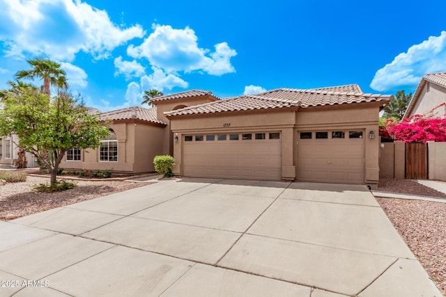 1777 W Redfield Rd, Gilbert, AZ 85233 - mediterranean / spanish-style house featuring an attached garage, stucco siding, and driveway