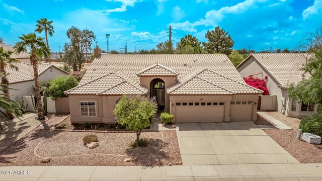 1777 W Redfield Rd, Gilbert, AZ 85233 - mediterranean / spanish-style house with an attached garage, a tile roof, stucco siding, and driveway
