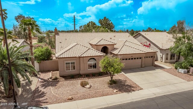 1777 W Redfield Rd, Gilbert, AZ 85233 - mediterranean / spanish home featuring fence, stucco siding, a tile roof, driveway, and a garage