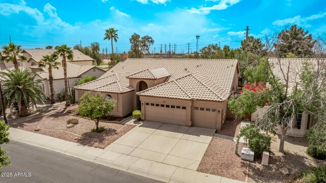 1777 W Redfield Rd, Gilbert, AZ 85233 - mediterranean / spanish home with a garage, driveway, a tiled roof, and stucco siding