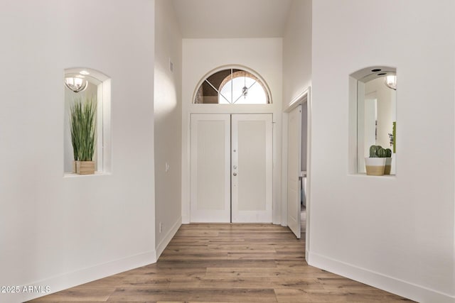 1777 W Redfield Rd, Gilbert, AZ 85233 - entrance foyer featuring arched walkways, baseboards, and light wood-type flooring