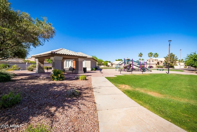 1777 W Redfield Rd, Gilbert, AZ 85233 - view of front of home with a tile roof, a front lawn, playground community, a gazebo, and stucco siding