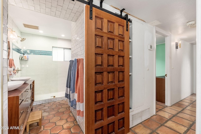 bathroom featuring vanity, a shower, and tile walls