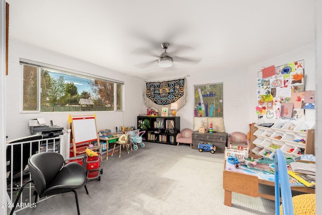 recreation room featuring carpet flooring and ceiling fan