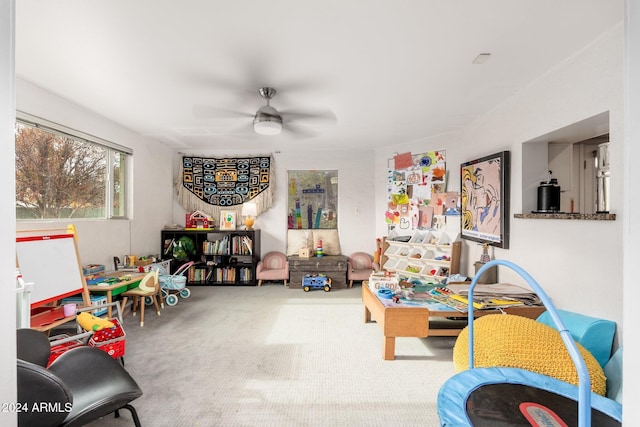 interior space with carpet flooring and ceiling fan