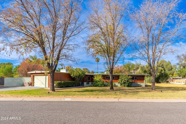 ranch-style home featuring a front yard and a garage