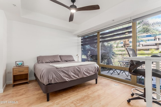 bedroom featuring baseboards, a ceiling fan, and light wood-style floors