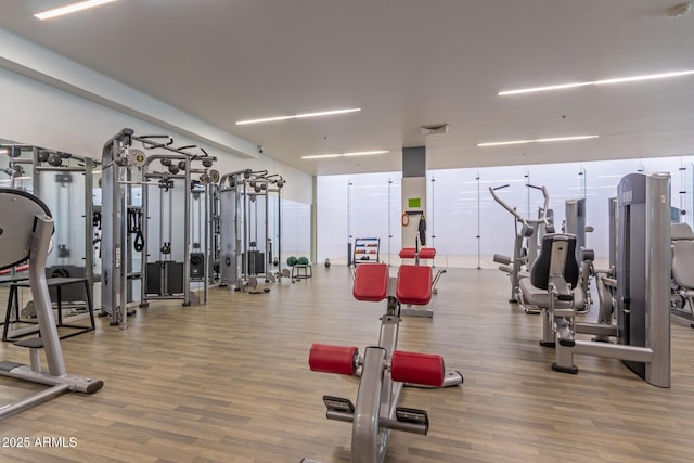 workout area featuring wood finished floors and visible vents