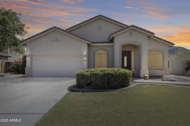 6742 W El Cortez Pl, Peoria, AZ 85383 - view of front of house featuring an attached garage, stucco siding, driveway, a tiled roof, and a front lawn