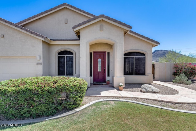 6742 W El Cortez Pl, Peoria, AZ 85383 - view of front of property featuring a garage, stucco siding, a tile roof, and a mountain view