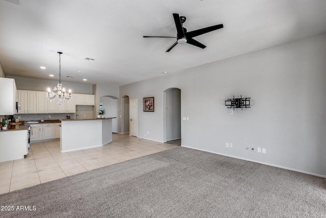 6742 W El Cortez Pl, Peoria, AZ 85383 - kitchen featuring arched walkways, a ceiling fan, recessed lighting, a chandelier, and light colored carpet