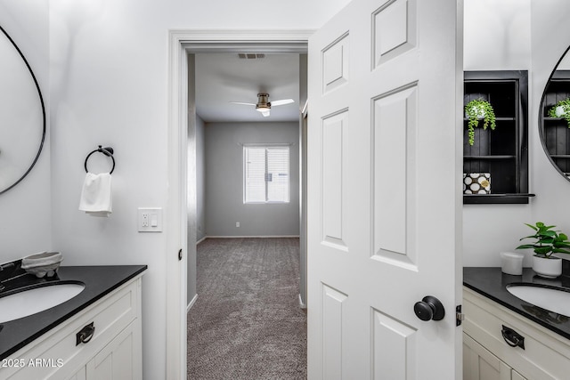 6742 W El Cortez Pl, Peoria, AZ 85383 - bathroom with a ceiling fan, two vanities, and baseboards