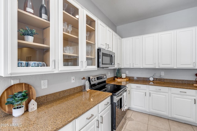 6742 W El Cortez Pl, Peoria, AZ 85383 - kitchen with stainless steel appliances, light tile patterned flooring, light stone countertops, and white cabinets