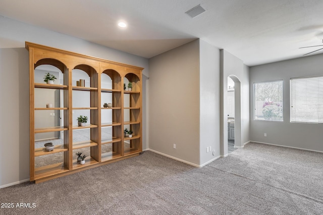 6742 W El Cortez Pl, Peoria, AZ 85383 - carpeted empty room with arched walkways, a ceiling fan, and baseboards
